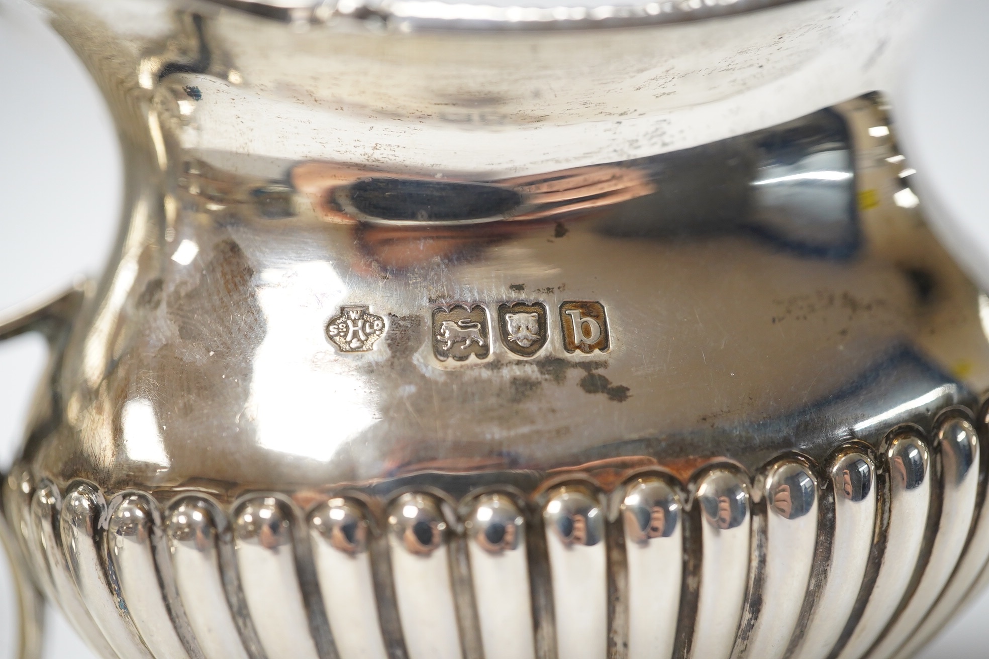 A late Victorian demi-fluted silver sugar bowl and a matching milk jug, by William Hutton & Sons, London, 1897, 12.6oz. Condition - good